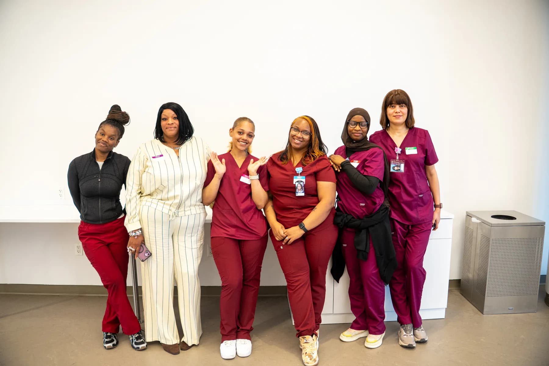 Uplift healthcare students standing proudly together in scrubs